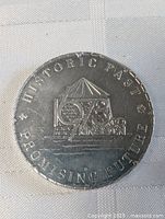 Clear image of the front side of the Kingston Frontenac 1973 commemorative dollar coin showing the detailed design and inscriptions.