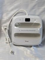 Front view of white Cricut EasyPress heat press machine showing digital display, control buttons, and branding.