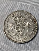 Obverse of the 1944 UK Silver Florin coin showing crowned emblem with thistle, shamrock, and rose with legible inscriptions.