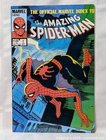 Front cover photo of The Official Marvel Index to The Amazing Spider-Man #1 comic book showing full cover art with Spider-Man swinging through cityscape.