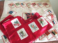Photo showing the red silk pillow cover with floral patches arranged in rows, highlighting textile detail and colors.