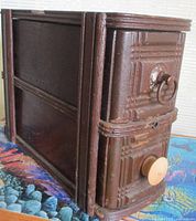 Front and side view highlighting the carved drawer fronts with metal pull and wooden knob and the wood grain on top and sides.