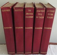 Five hardcover books by E. W. Hornung in red cloth binding with gilt spine titles, standing vertically.