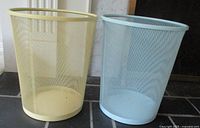 Side-by-side image of the two mesh waste baskets in pastel yellow and blue, showing the color and condition of the mesh.