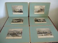 Six vintage colored Bartlett placemats laid flat showing all placemats with teal borders and central maritime scenes.