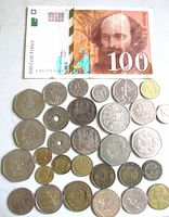 Photo of vintage 1997 French 100 Francs banknote alongside assorted French coins of various denominations and designs.