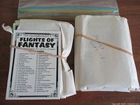 Bundles of Flights of Fantasy cards wrapped in white paper and secured with rubber bands, along with checklist card visible