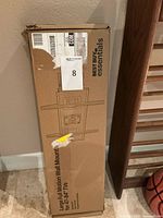 Box of Best Buy Essentials Large Full Motion TV Wall Mount for 47 to 84 inch TVs, showing exterior packaging with brand and basic illustration.