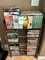 Full view of wooden media rack filled with DVDs and music DVDs/CDs