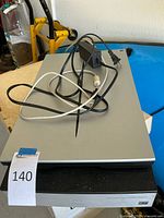 Top view of scanner with power adapter and USB cable arranged on top