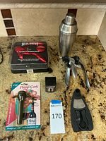 Wide view of entire set on countertop showing all pieces together including boxed corkscrew, foil cutter, wine stopper, pump cork, cocktail shaker, and mixing tool.