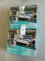 Two unopened boxed Intex River Run 1 Lounge inflatable water float tubes stacked, showing product image and branding.