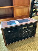Overview of entire cassette deck showing wood case, top ventilation grille and front control panel