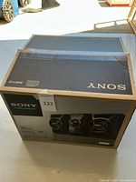 Box of the Sony MHC-EC609iP showing front with speaker images and product name.