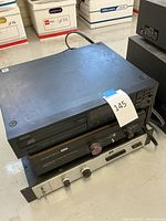 Three stacked units viewed from above on tabletop with visible power cords.