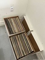 Two cardboard record boxes filled with vinyl LP sleeves