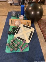 Overview of exercise equipment and weights on blue mat