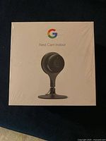 Front of the sealed Google Nest Cam Indoor white box showing the camera image and Google logo.