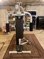 Front view of the ParaBody EX350 exercise machine showing the padded seat, arm pads, and white metal frame.