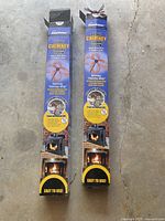 Front view of two opened boxes of SootEater Rotary Chimney Cleaning System for chimney cleaning, each showing the spinning chimney whip and easy to use label.