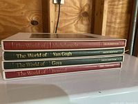 Stacked view of four Time Life World of Art hardcover books with titles Michelangelo, Van Gogh, Goya, and Bruegel.