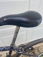 Close-up of Cannondale F900 mountain bike's original Mountain Bicycle saddle showing wear and paint chips.