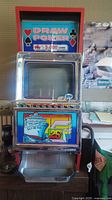 Front view of the vintage Draw Poker slot machine showing the game title, coin slot, and play screen.
