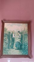 Full view of the framed vintage artwork showing the couple by the gate.