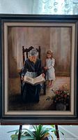 Framed painting of elderly woman reading to a child, signed artwork.