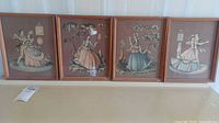 Four vintage framed art pieces displayed side by side, showing dancing couples in classical attire with decorative backgrounds
