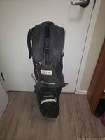 Front view showing overall bag, straps, and tag