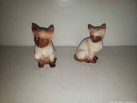 front view of both ceramic Siamese cat shakers