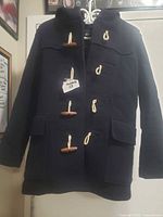 Front view showing toggles, pockets, overall style