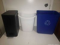 front view of three bins showing colours, shapes and recycle symbol