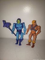 Front view of He-Man and Skeletor with accessories