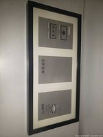 Full view of black IKEA RIBBA frame with three mat openings