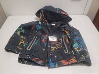 Front view of coat showing pattern, hood, pockets, zipper