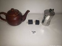 Group shot of teapot, moka pot and two USB chargers