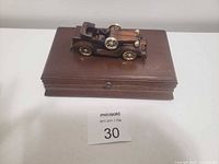 Closed jewelry box showing car topper and clasp