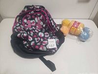 Backpack and packaged yarn on table
