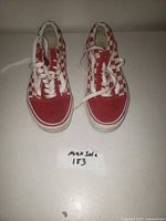 Top view of the pair of red checkerboard Vans sneakers