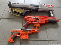 Overall view of three Nerf blasters laid out