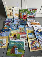 Overview of entire lot of children’s books spread on floor