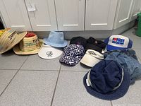 Group shot of all ten hats on floor
