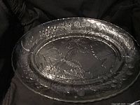 Full view of clear pressed glass oval platter showing overall size and relief pattern