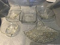 Group shot of five clear glass serving pieces