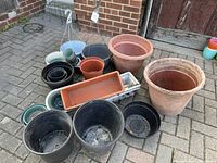 Full group of plastic planters arranged on patio