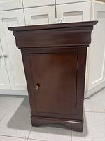 Front view of brown wooden cabinet with closed door