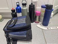 Group shot showing lunch bag and eight water bottles