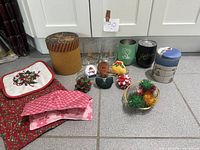 Overview of entire lot including textiles, drinkware, tins and ornaments